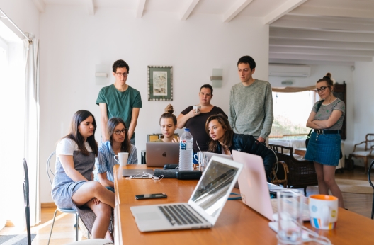 group of people watching on laptop 1595385