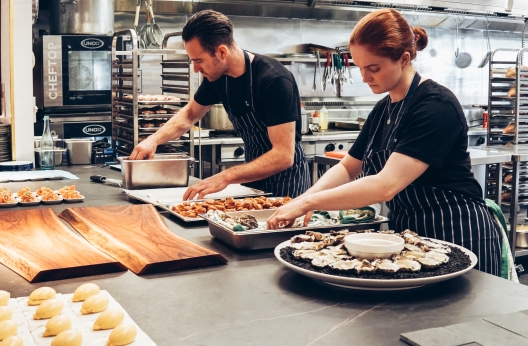 man and woman wearing black and white striped aprons 2696064